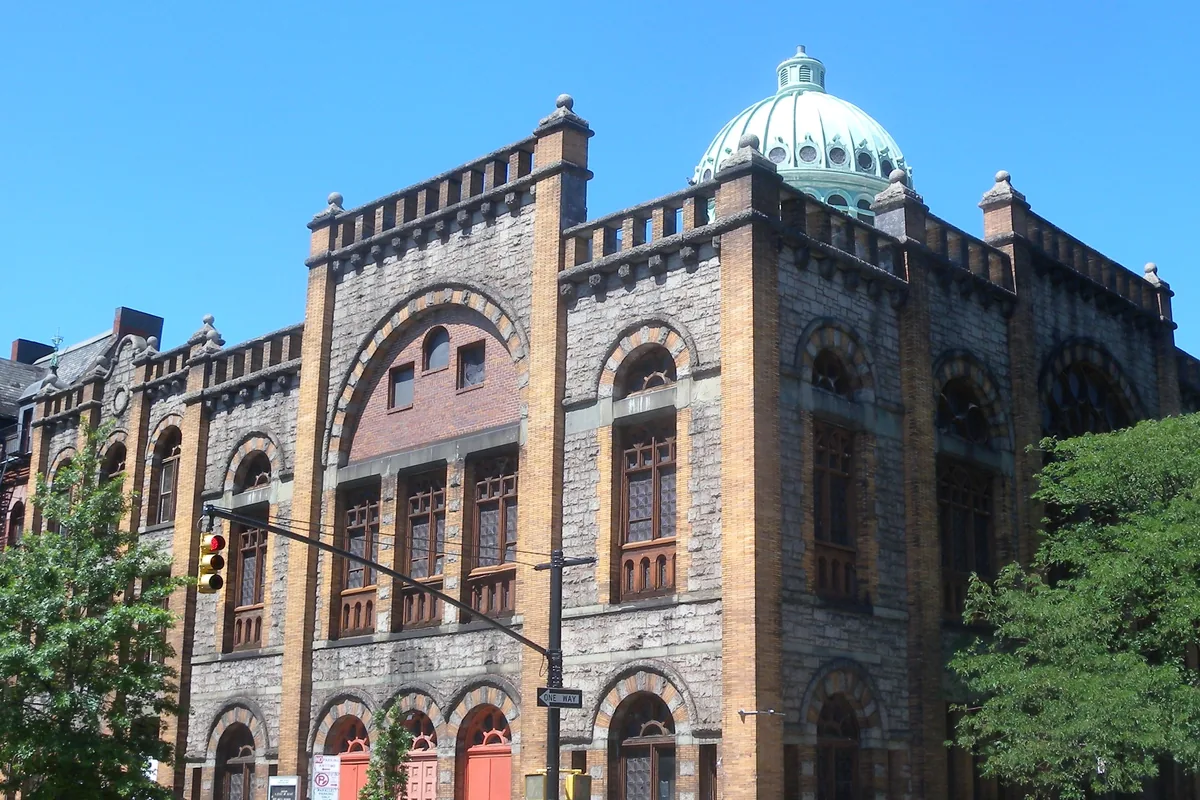 Mount Morris Ascension Presbyterian Church in Harlem, a granite and gold-brick building with a green copper dome, seen from across the street