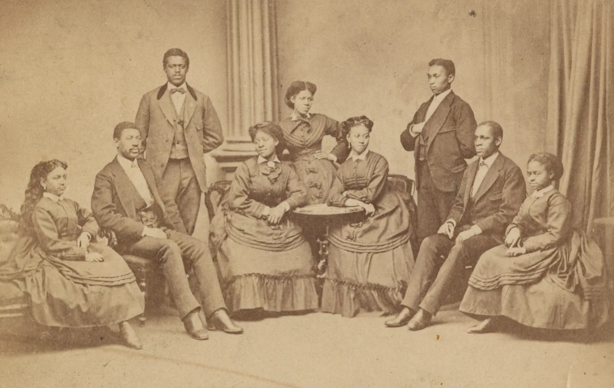 A nineteenth-century group portrait of the Fisk Jubilee Singers in formal dress, mounted on a carte de visite card